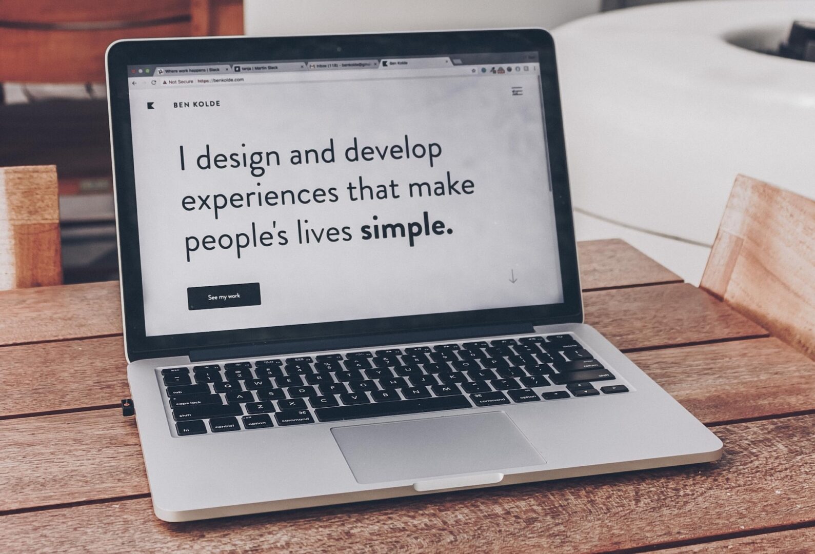 Laptop with Quote "I design and develop experiences that make people's lives simple."